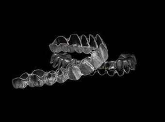 Clear aligners on a black background